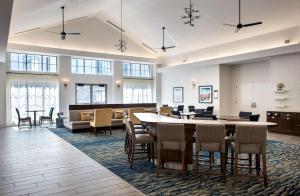 a lobby with a large table and chairs at Homewood Suites by Hilton Newburgh-Stewart Airport in New Windsor