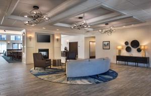 een lobby met een bank en stoelen en een woonkamer bij Homewood Suites by Hilton Newburgh-Stewart Airport in New Windsor