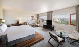 A bed or beds in a room at Transcorp Hilton Abuja