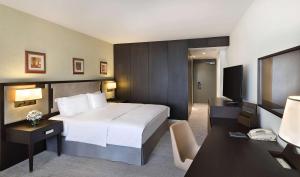 A bed or beds in a room at Transcorp Hilton Abuja