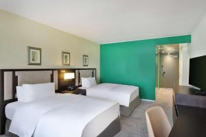 A bed or beds in a room at Transcorp Hilton Abuja