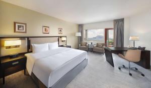 A bed or beds in a room at Transcorp Hilton Abuja