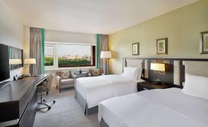 A bed or beds in a room at Transcorp Hilton Abuja