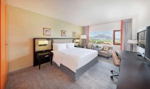 A bed or beds in a room at Transcorp Hilton Abuja