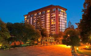 a large building at night with a park in front of it at Hilton Addis Ababa in Addis Ababa