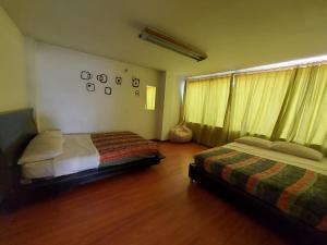 a bedroom with two beds and a window at North House Hostel in Bogotá