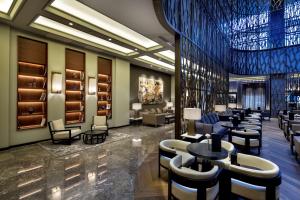 a lobby of a hotel with tables and chairs at Ankara HiltonSA in Ankara