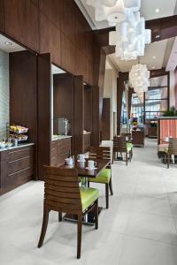 a restaurant with wooden walls and wooden tables and chairs at Hilton Garden Inn Atlanta Midtown in Atlanta