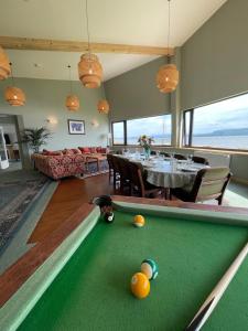 a living room with a pool table and a dining room at Spacious Sea View Home 5 miles from Inverness in North Kessock