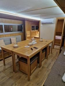 a large wooden table in a room on a boat at Free Room Boat Apartment in Belgrade