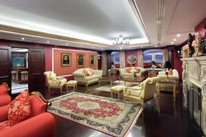 a living room filled with furniture and a fireplace at Hilton Beirut Metropolitan Palace Hotel in Beirut