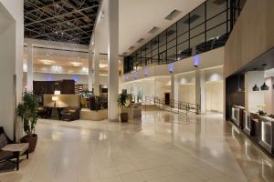 an empty lobby of a building with tables and chairs at Hilton Stamford Hotel & Executive Meeting Center in Stamford