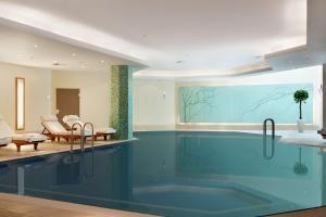 a bathroom with a large swimming pool in a house at Hilton Berlin in Berlin