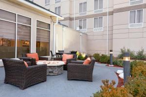 a patio with wicker chairs and a fire pit at Hilton Garden Inn Tuscaloosa in Tuscaloosa