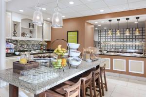 a kitchen with a counter with food on it at Hilton Garden Inn Tuscaloosa in Tuscaloosa