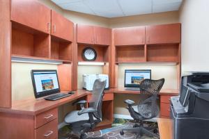 a office with two computer desks and two chairs at Hilton Garden Inn Tuscaloosa in Tuscaloosa