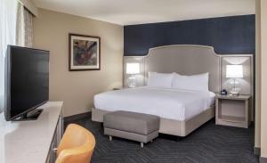 a hotel room with a bed and a flat screen tv at DoubleTree by Hilton Hotel Nashville Downtown in Nashville