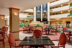 a restaurant with tables and chairs in a courtyard at Embassy Suites by Hilton Columbia Greystone in Columbia