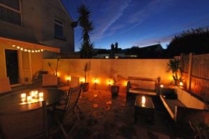 a patio with a table and chairs and lights at The Crow's Nest in Broadstairs