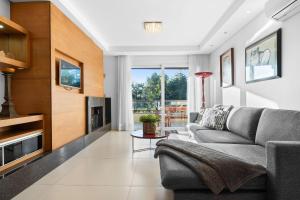 a living room with a couch and a fireplace at Residencial Villa Verde - 403 B in Gramado