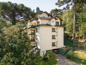 an apartment building in the middle of a forest at Residencial Villa Verde - 403 B in Gramado
