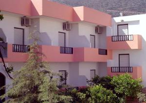 a building with balconies on the side of it at Hotel Thisvi in Stalís