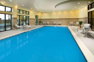 a pool in a hotel with chairs and tables at Hampton Inn & Suites Chattanooga/Hamilton Place in Chattanooga