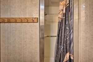 a shower with a shower curtain in a bathroom at 5 Mi to Raystown Lake Launch Lucas McCain Cabin in Huntingdon +29 photos