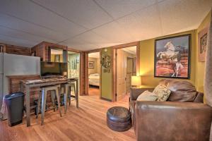 ein Wohnzimmer mit einem Sofa, einem Tisch und einem Kühlschrank in der Unterkunft Lone Ranger Cabin with 50 Acres by Raystown Lake in Huntingdon