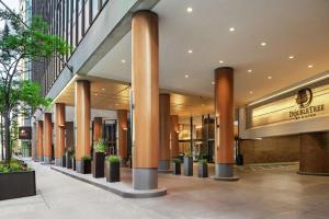 a lobby of a building with columns and plants at DoubleTree by Hilton Chicago Magnificent Mile in Chicago