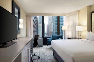 a hotel room with a bed and a large window at DoubleTree by Hilton Chicago Magnificent Mile in Chicago
