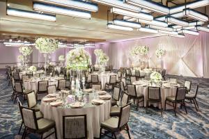 a banquet room with white tables and chairs and chandeliers at DoubleTree by Hilton Chicago Magnificent Mile in Chicago