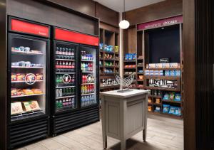 a grocery store aisle with a refrigerator and a counter at Hampton Inn Chicago Downtown/Magnificent Mile in Chicago