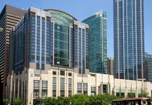 a building in front of some tall buildings at Embassy Suites by Hilton Chicago Downtown Magnificent Mile in Chicago