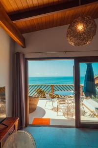 a living room with a view of the ocean at Altavista residence in Morro de São Paulo