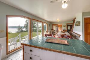 a kitchen and living room with a view of the ocean at Shorefront House with Views, 14 Mi to Acadia NP in Sullivan