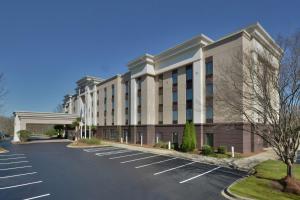 a parking lot in front of a large building at Hampton Inn & Suites Clinton in Clinton