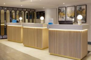 a lobby with a row of wooden dividers in a room at Hilton Cobham in Cobham