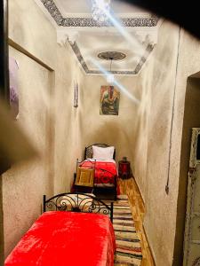a room with two beds with red sheets in it at Hostel Marrakech Rouge in Marrakesh