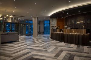 a lobby with a bar in a building at Hilton Cardiff in Cardiff