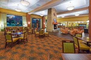 a restaurant with tables and chairs and a fireplace at Hampton Inn & Suites Dallas-Mesquite in Mesquite