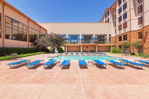 a swimming pool with lounge chairs and a building at Hampton Inn & Suites Dallas-Mesquite in Mesquite
