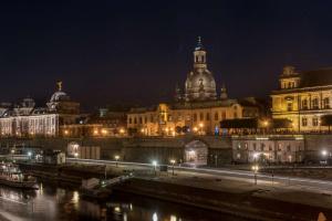 a view of a city at night with buildings at Hilton Dresden an der Frauenkirche in Dresden