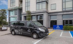 a black van parked in front of a building at Hilton Dublin Airport in Cloghran