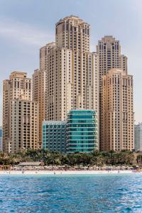 a skyline of a city with a beach and tall buildings at Hilton Dubai Jumeirah in Dubai