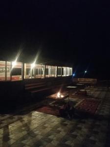 a train station at night with benches and a train at Omar Ghazi Camp in Wadi Rum