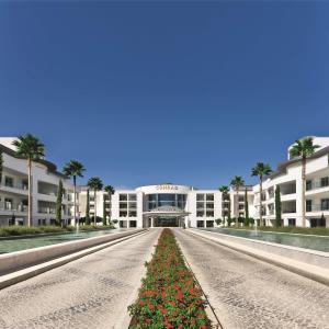 a large white building with a road in front of it at Conrad Algarve in Quinta do Lago