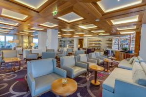 a waiting room with blue chairs and tables at Conrad Algarve in Quinta do Lago