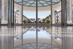 a rendering of the lobby of a building with a reflection in the water at Conrad Algarve in Quinta do Lago