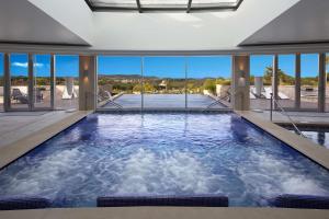 a swimming pool in a house with a view at Conrad Algarve in Quinta do Lago